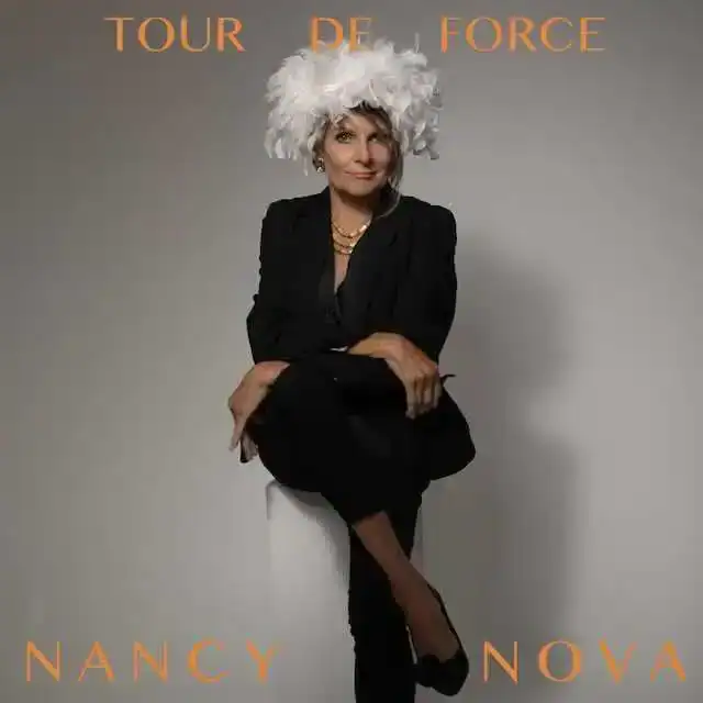 Elegant woman in black suit with feathered hat for Divine Magazine.