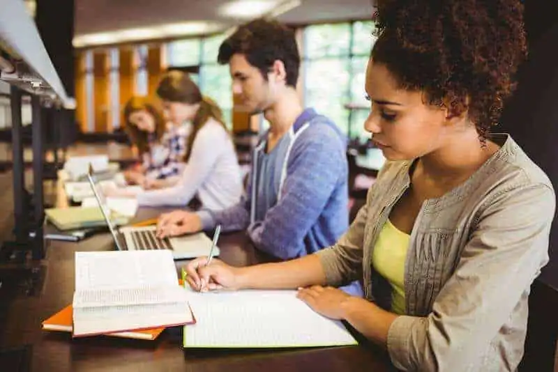 Diverse students studying together in a library for academic growth and collaboration.